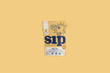 Sip Herbals Cinnamon Roll blend front pouch on warm yellow background displaying brand logo and product name